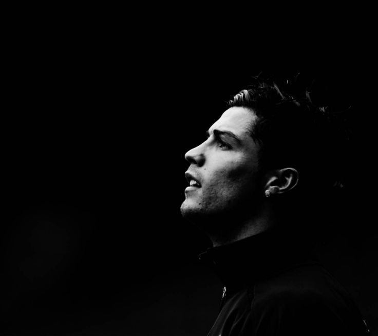 a black and white photo of a man with his head tilted to the side looking up