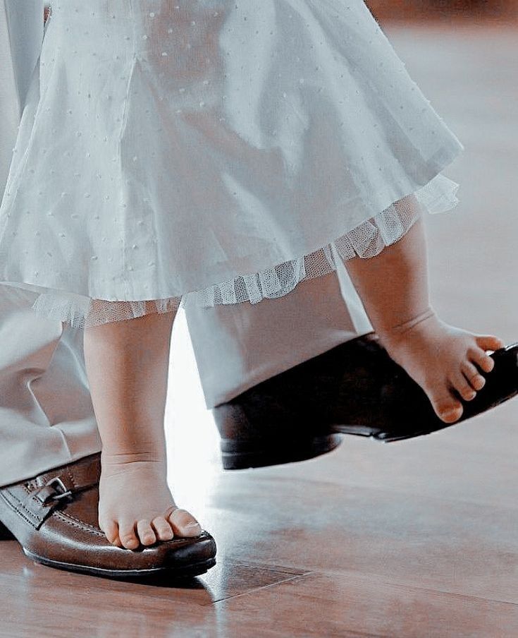 the feet of two people in wedding shoes