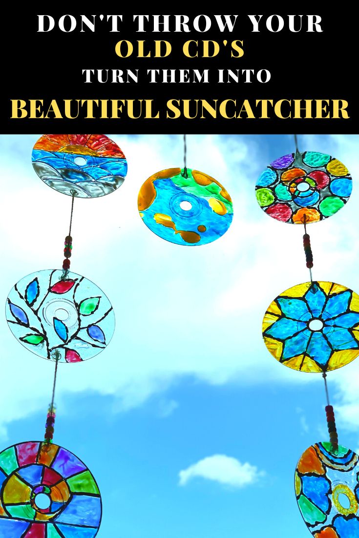 colorful stained glass sun catchers hanging from strings with the words, don't throw your old cds turn them into beautiful sun catchers