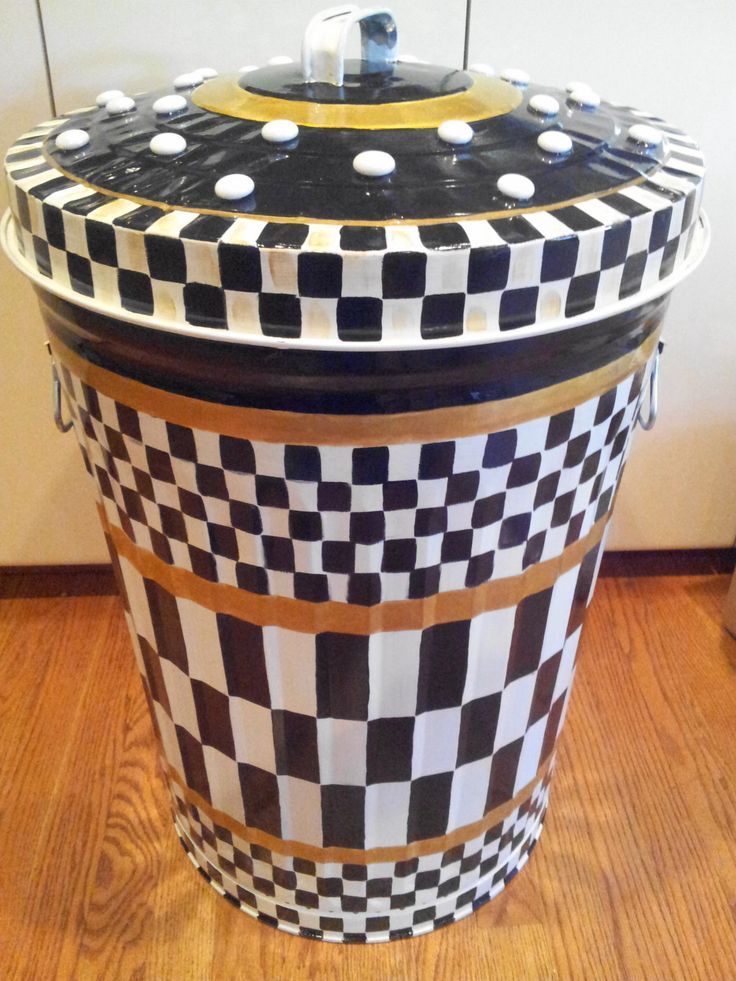 a black and white checkerboard container sitting on top of a hard wood floor