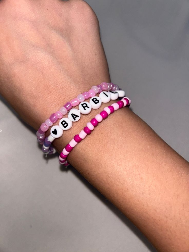 a person's arm with two bracelets on it and the words bead together