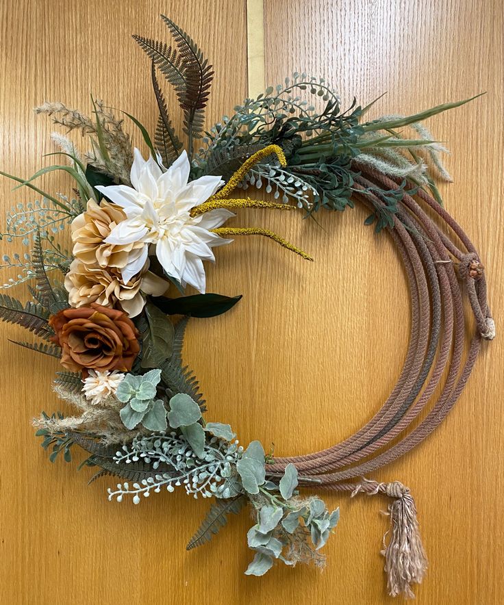 a wreath made out of flowers and leaves