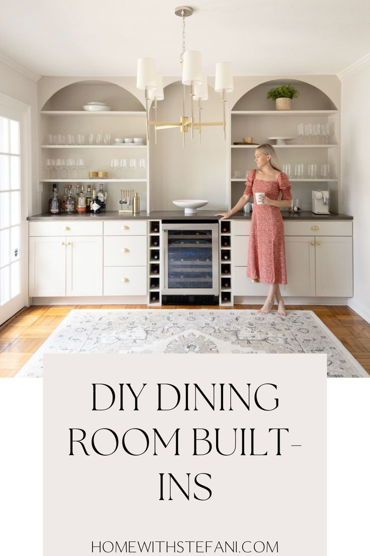 a woman standing in the middle of a kitchen with white cabinets and an area rug that says diy dining room built - ins