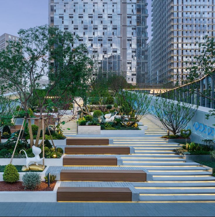 an outdoor garden with steps leading up to trees and bushes in the foreground, surrounded by tall buildings