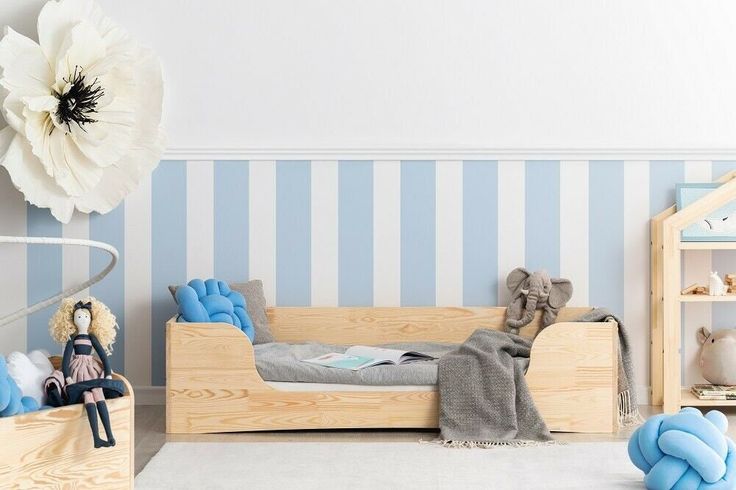 a child's bedroom with blue and white striped walls