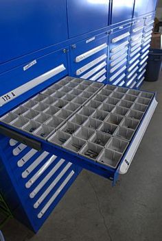 a large blue tool cabinet filled with lots of drawers