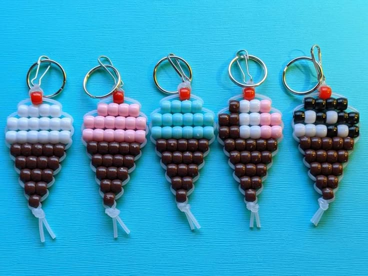 four different shaped key chains with beads on them, one has an ice cream cone in the middle