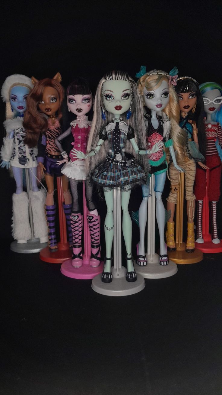 a group of monster dolls standing next to each other