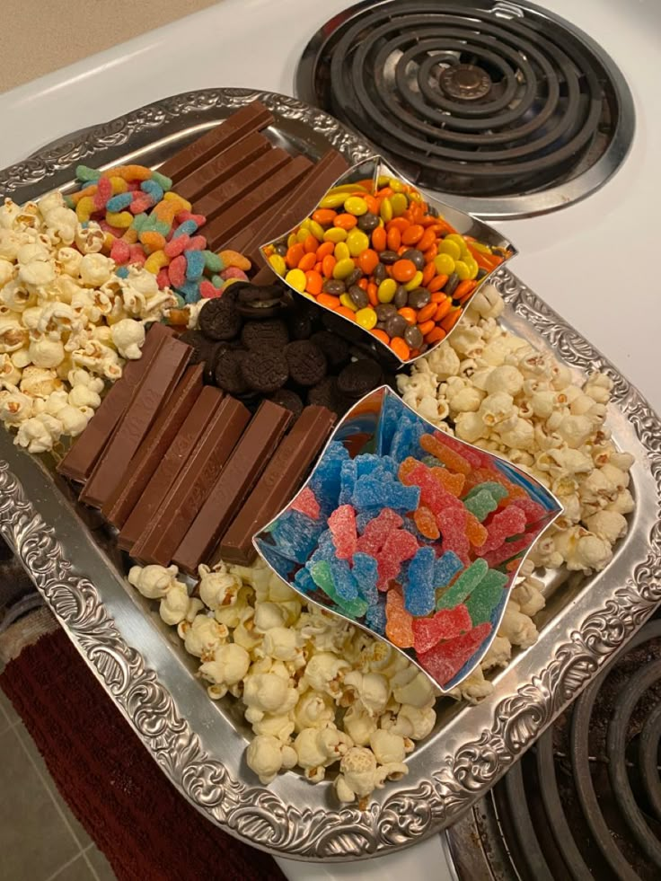 a tray filled with candy and candies on top of a stove