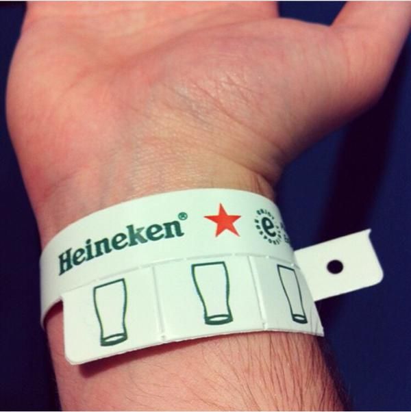 a hand with a wristband that has beer mugs on it