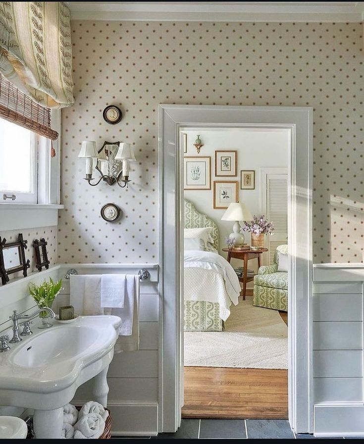 a white sink sitting under a mirror in a bathroom