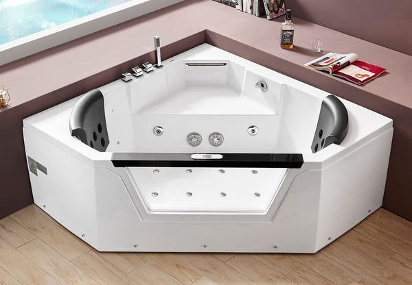 a large white bath tub sitting on top of a wooden floor next to a window