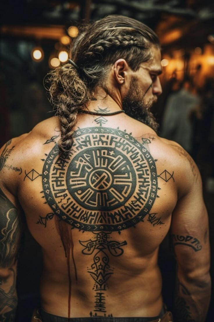 a man with long hair and tattoos on his back