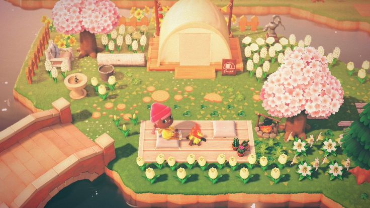 an animal crossing the street in front of a tent and trees with flowers on it