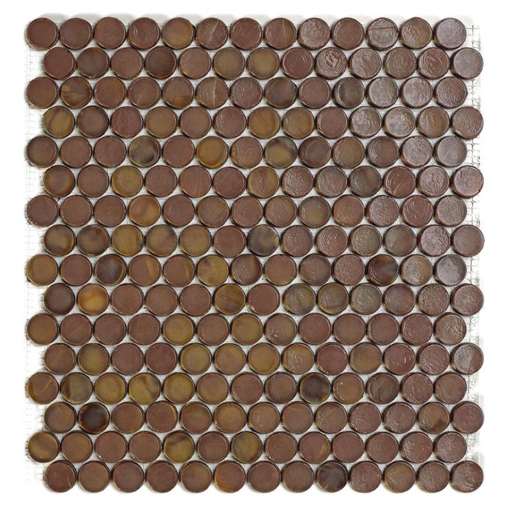 an old penny tile is displayed on a white surface with brown circles in the middle