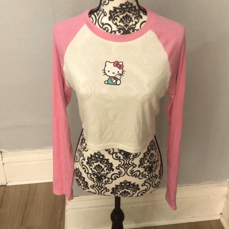 This Is A Pink And White Hello Kitty Long Sleeve Crop Top. It’s Ribbed And A Bit See Through. Also Has Some Wrinkles Due To Being In Storage, But Still In Good Condition Because It’s Brand New. Great For Any Hello Kitty Fan Fitted Cotton Hello Kitty Top, Fitted Hello Kitty Top For Spring, Fitted Hello Kitty Tops For Spring, Spring Fitted Hello Kitty Tops, White Y2k Cat Print Top, Y2k White Cat Print Top, White Y2k Style Cat Print Top, Hello Kitty Print Stretch Top For Summer, Stretch Hello Kitty Print Top For Summer