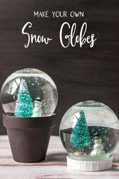 two snow globes sitting on top of a table