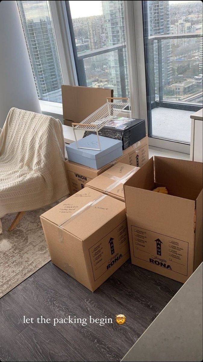 several boxes stacked on top of each other in front of a window with city view