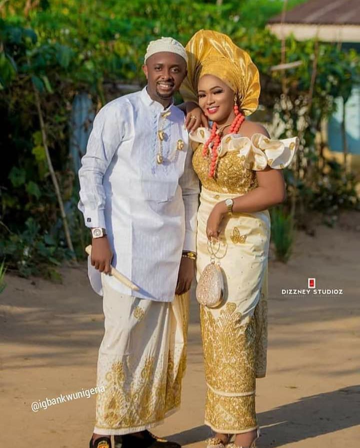 a man and woman dressed in traditional african clothing