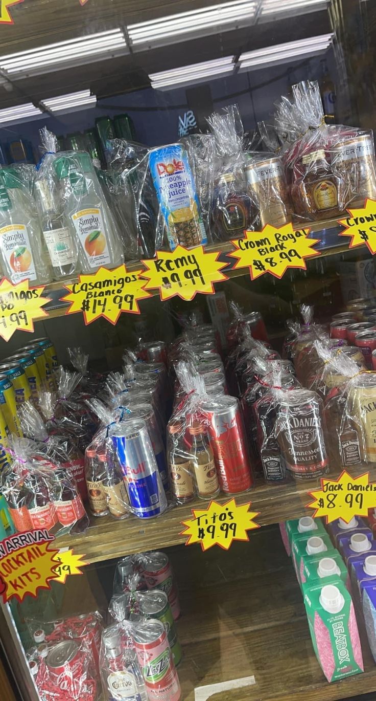 a display case in a store filled with lots of different types of drinks and condiments