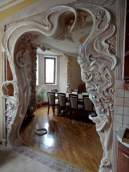 an ornate archway in the middle of a dining room