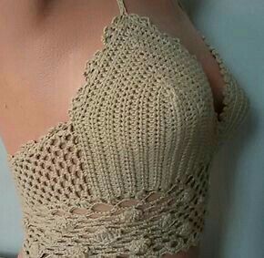 a woman wearing a crochet top with an open back