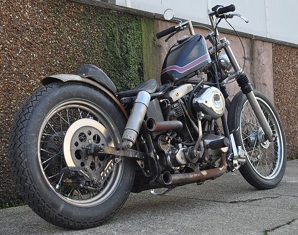 a black motorcycle parked next to a building