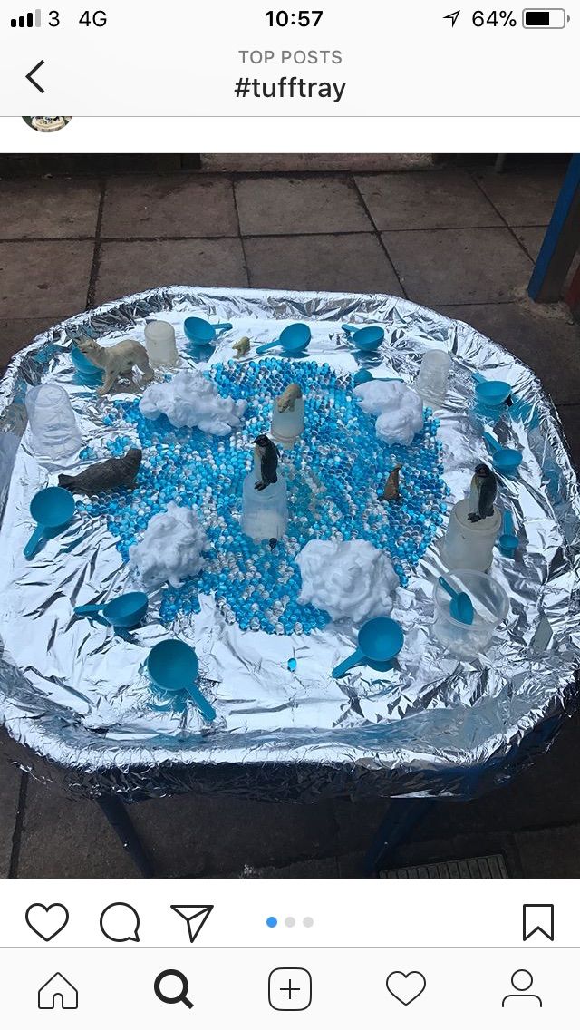 a tin foil covered tray with blue and white frosting on it, sitting on a sidewalk