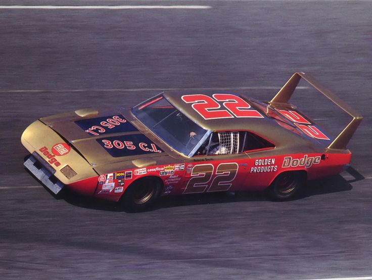 a race car driving down the track with numbers painted on it's side and number 22 on the front