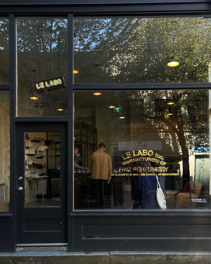 a store front with people standing in the window