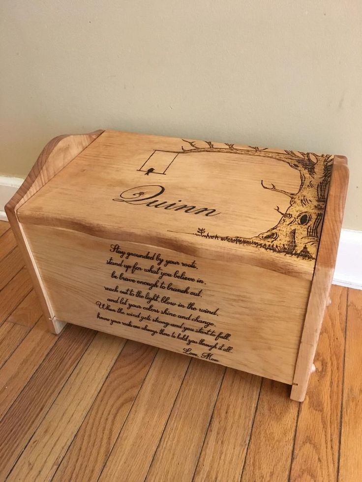 a wooden box with writing on it sitting on the floor