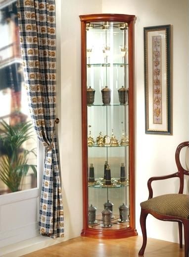 a corner of a room with a chair and a china cabinet