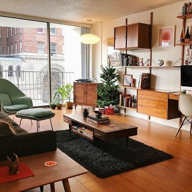 a living room filled with furniture and a flat screen tv sitting on top of a wooden table