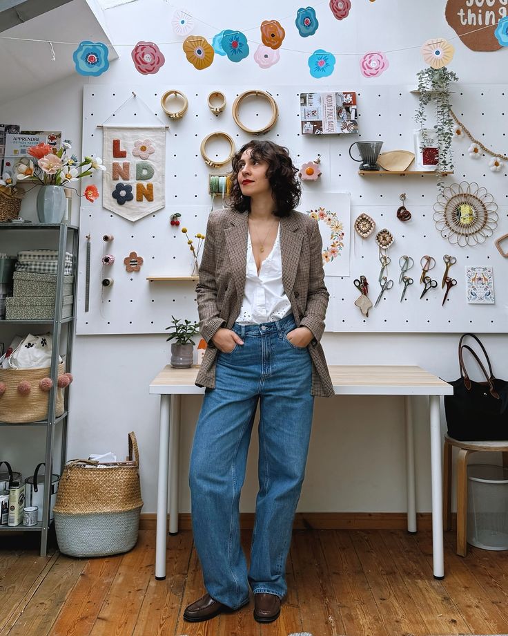 a woman standing in front of a wall with donuts on it