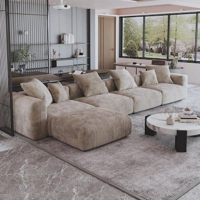 a living room filled with furniture and large windows