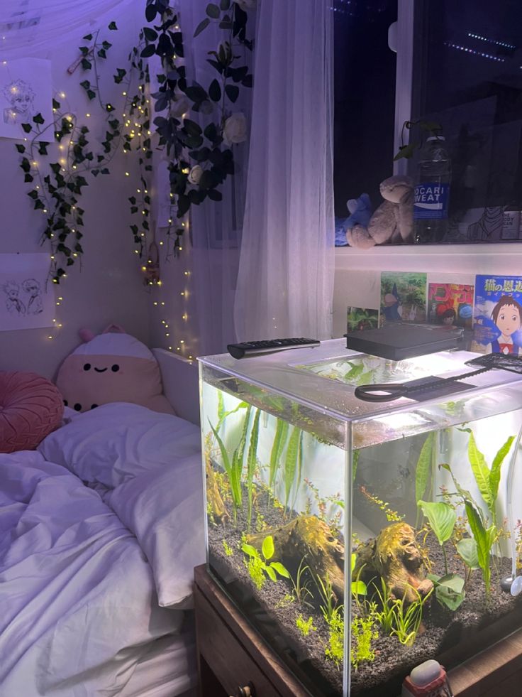 there is a fish tank in the middle of a bed with plants growing out of it