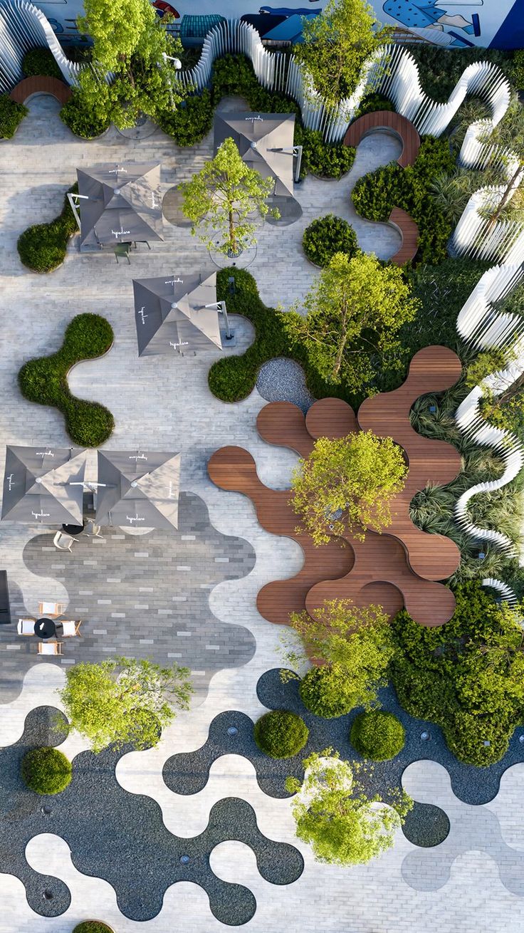 an aerial view of a park with trees and benches