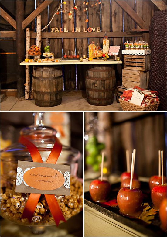 an assortment of apples and candies on display in front of wooden barrels with signs that read fall in love