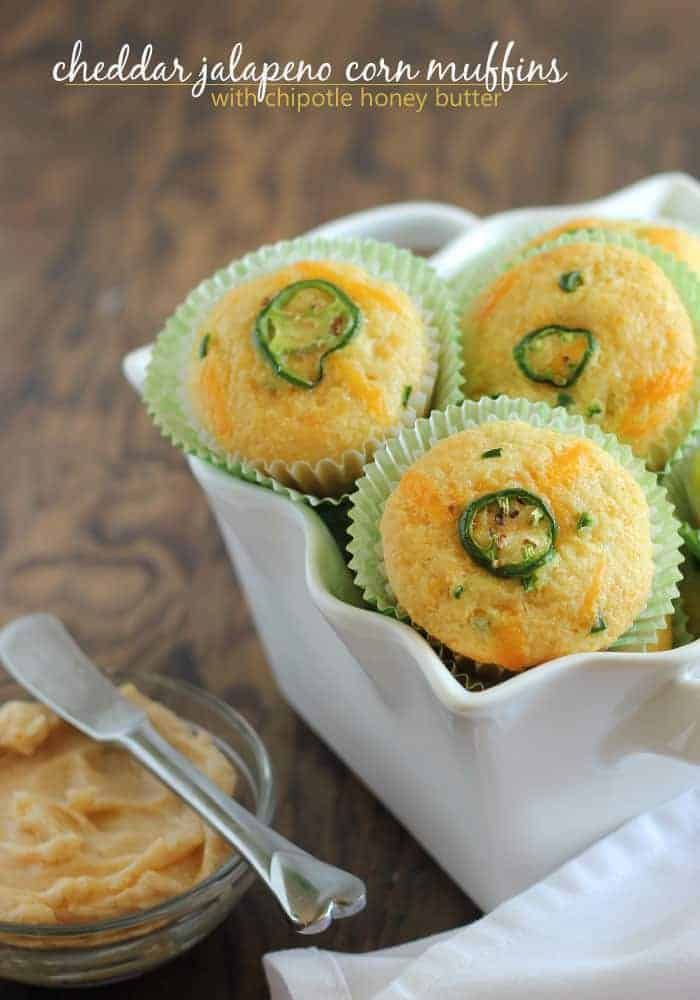 small cupcakes with jalapenos on top in a white dish next to a jar of peanut butter