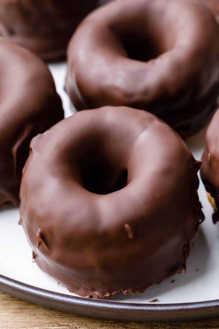 chocolate covered doughnuts on a plate ready to be eaten for breakfast or dessert