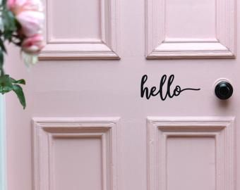 a pink door with the word hello written on it