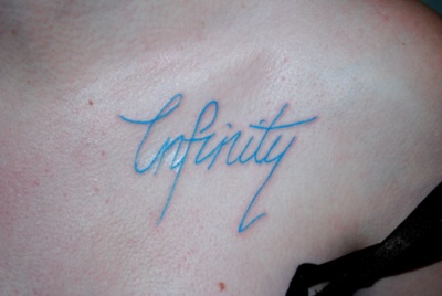 a woman's chest with the word opportunity written in cursive blue ink