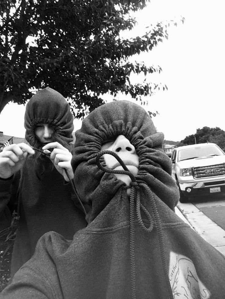 two people with masks on walking down the street