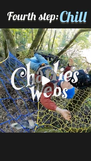 a man laying on top of a net in the woods