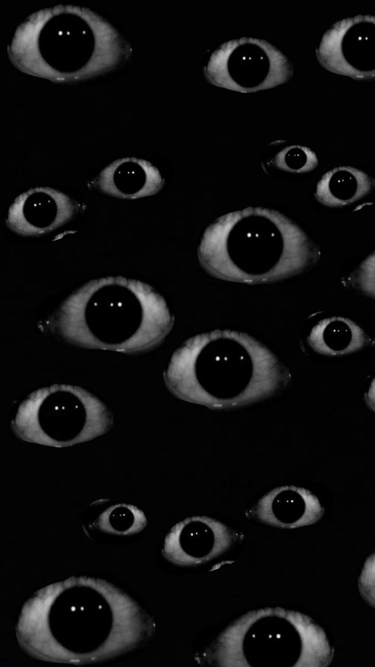 an image of many eyes in the dark