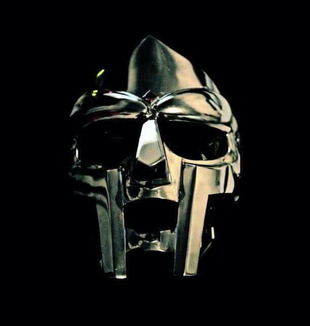 a metal mask with two knives sticking out of it's face in the dark