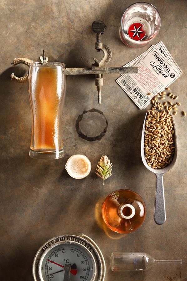 an overhead view of beer and other items on a counter top, including a measuring cup