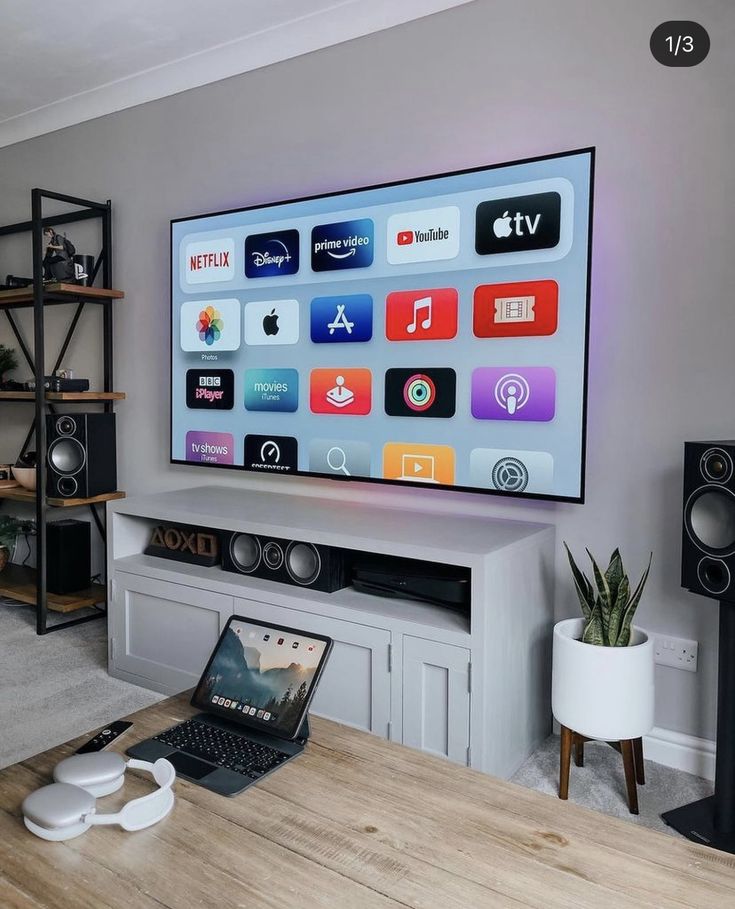 a flat screen tv sitting on top of a wooden table