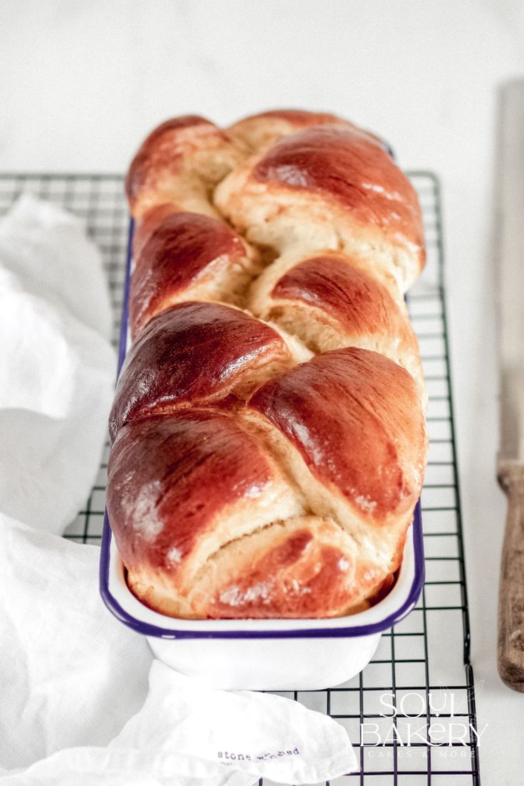 a loaf of bread sitting on top of a blue and white plate next to a knife