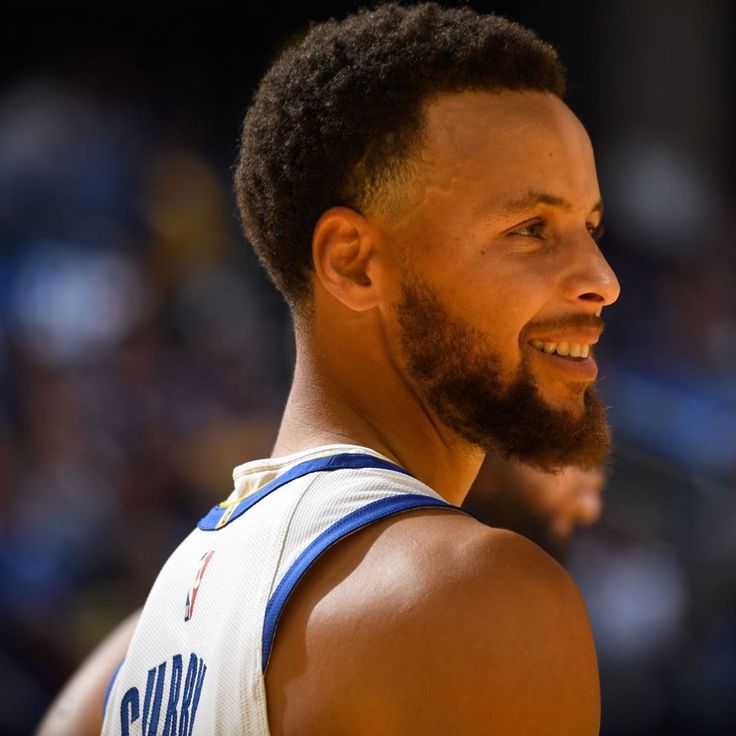 a close up of a basketball player with a beard